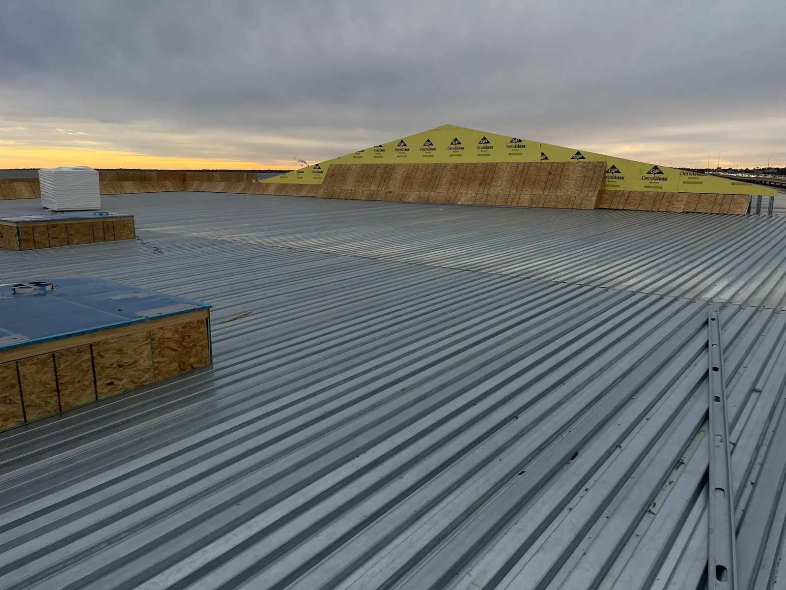 Bare steel deck with framed parapets at sunset