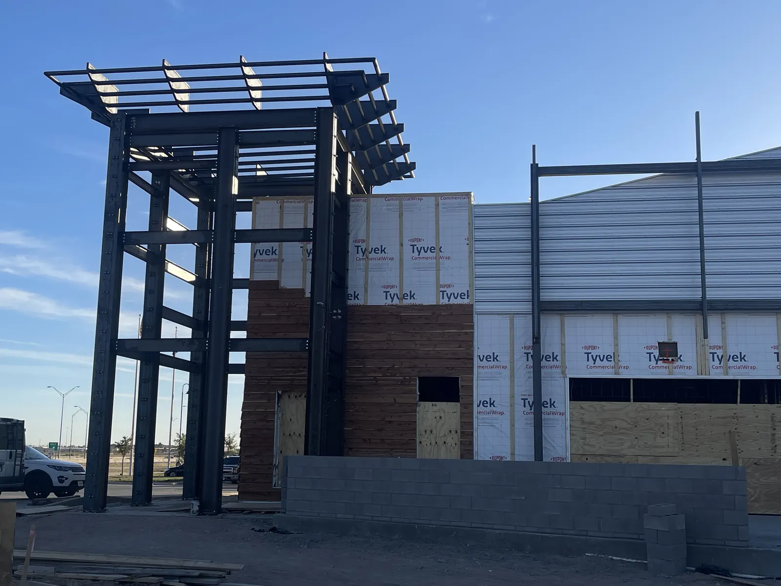 Ground-up commercial building with structural steel tower, air barrier and sheathing during construction