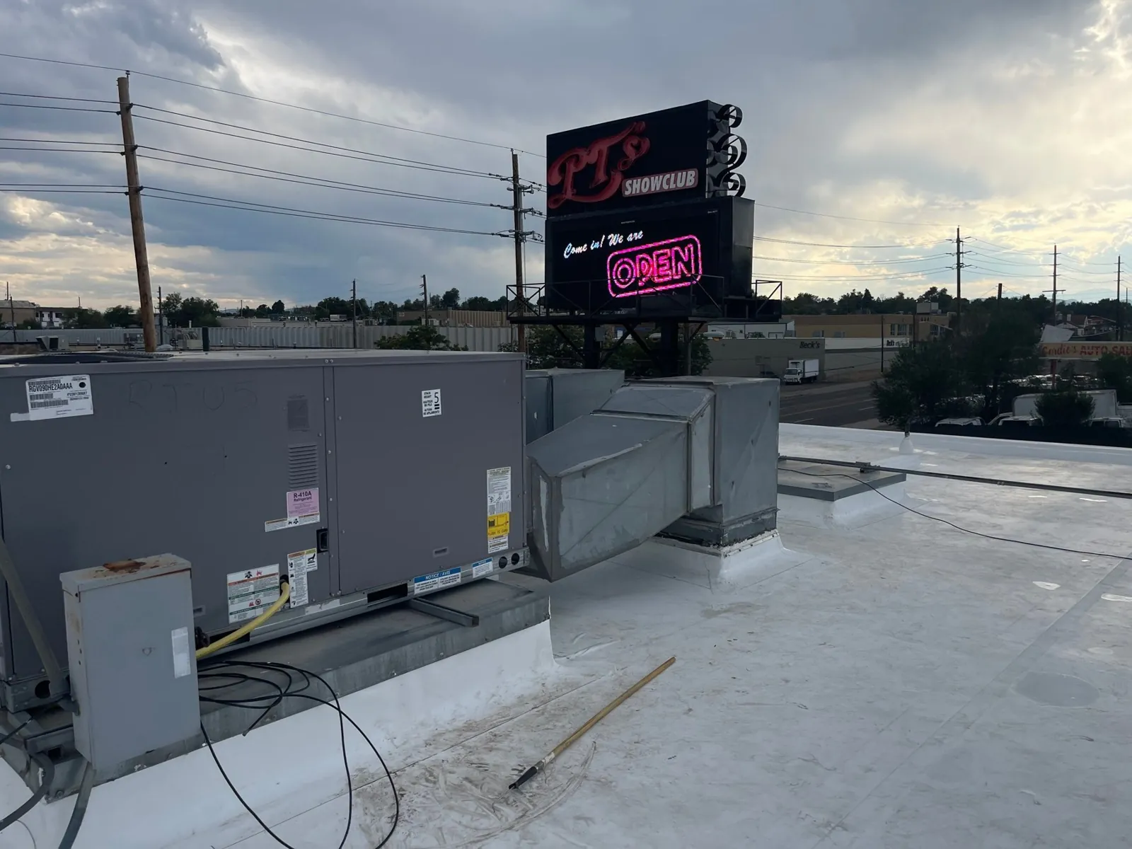 Finished roof at dusk with the club sign lit