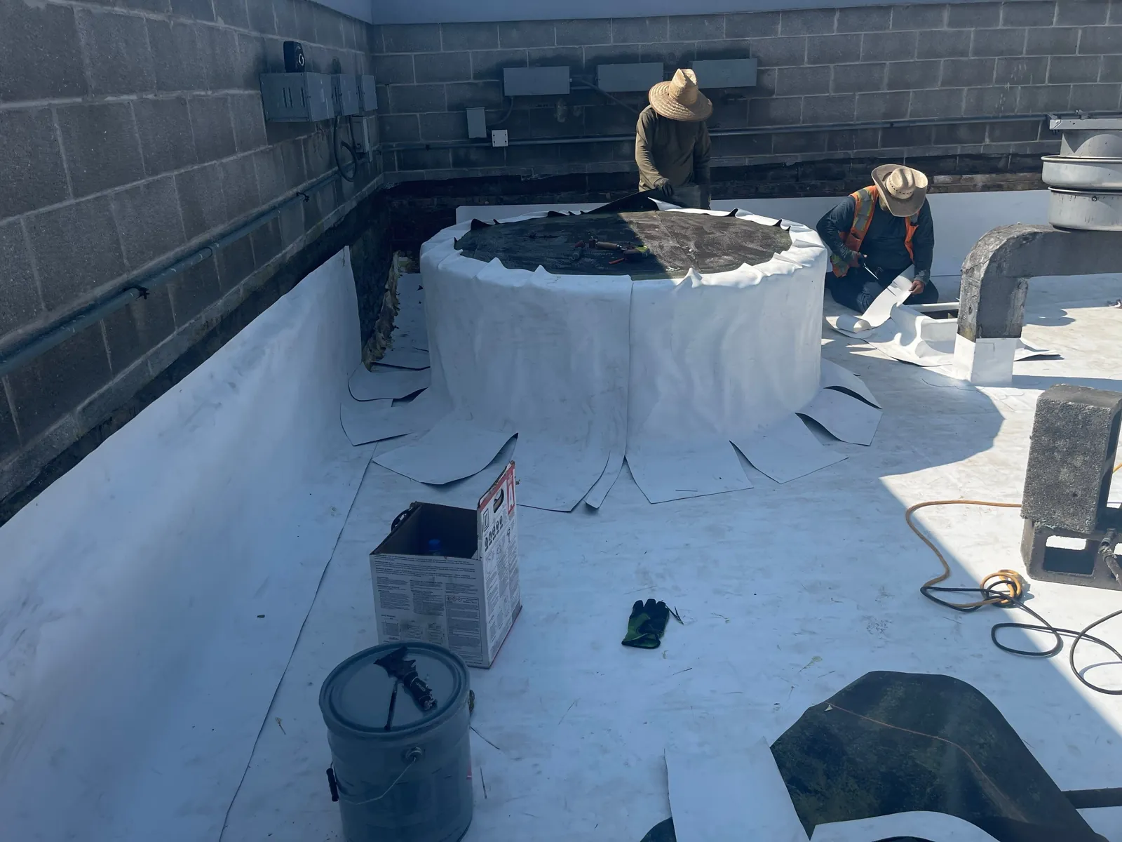Round kitchen exhaust base flashed in new TPO